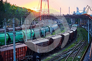 Railroad transportation, freight cars in industrial seaport at sunset