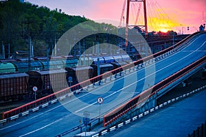 Railroad transportation, freight cars in industrial seaport at sunset