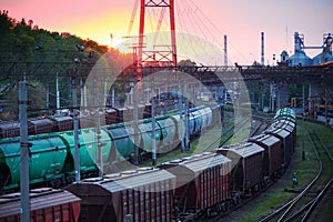 Railroad transportation, freight cars in industrial seaport at sunset