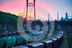 Railroad transportation, freight cars in industrial seaport at sunset