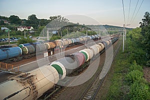 Railroad transportation, tourism travel. Evening Railway platform and station. Industrial concept, cargo freight train background