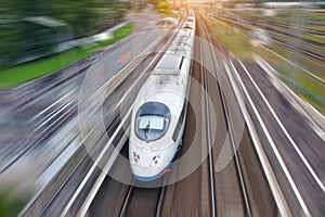 Railroad travel high speed fast train passenger locomotive motion blur effect in the city, top aerial view from above