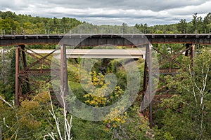 Railroad Trestle Bridge With Highway Bridge Behind