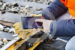 Railroad worker using tablet PC on railway