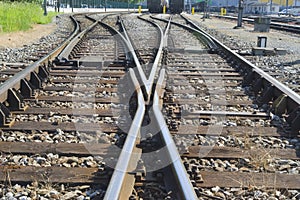 Railroad yard with two cars in the distance