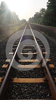 Railroads with yellow pads of concrete and pebbles around it