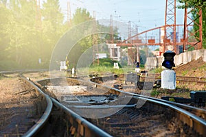 The rails and the arrow for the railway, the fork of the road. Tinted image