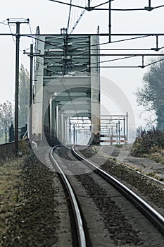 Rails and an old steel railway bridge