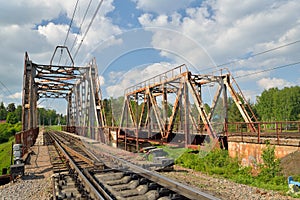 Railway bridge across the river and the rails with the arrow in