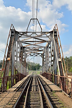 Railway bridge across the river and the rails with the arrow in