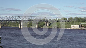 The railway bridge across the Volkhov River. Russia, seagulls are able to fly over river water to summer sunny day