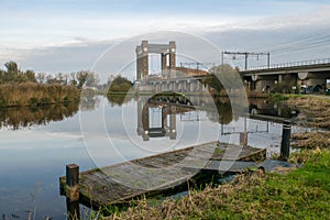 Railway bridge in Gouda, Holland with jetty on the waterfront