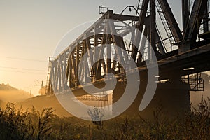 Railway bridge over the Irpin River in the autumn foggy morning