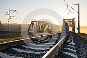 Railway bridge over the Irpin River in the autumn foggy morning. photo