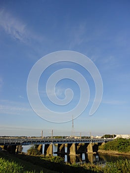 Railway bridge over Kokai River with autumn blue sky