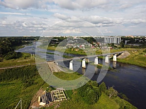 railway bridge over the Luga river in the city of Kingisepp Leningrad region Russia aerial photo in a summer day photo