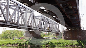 Railway bridge over the river, bottom view in the summer