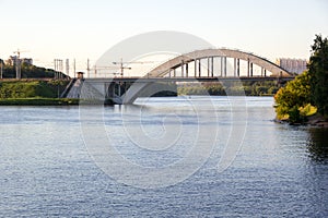 Railway bridge over river in evening photo