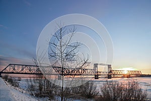 Railway bridge over the river Northern Dvina in the city of Arkhangelsk. Winter dawn; December