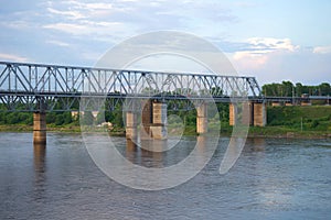 Railway bridge over the Volkhov river in the summer dusk. Leningrad region