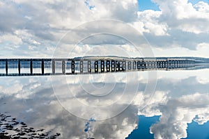 Railway Bridge over a wide river and cloudy sky