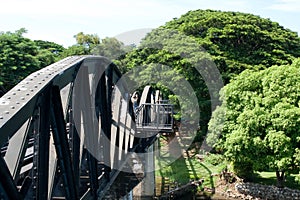 A railway Bridge on the River Kwai is a river in western Thailand at Kanchanaburi province with hills and forests.