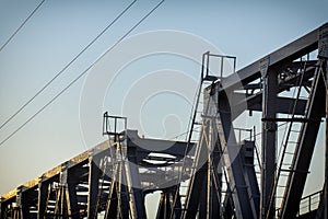 railway bridge of steel structures, on a sunset background