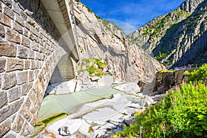 Railway bridge Teufelsbrucke over Reuss river in St. Gotthard mountain range of Swiss Alps near Andermatt