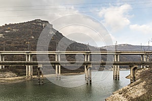 A railway bridge with trains passing over Tsonevo dam.