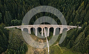 Railway bridge - Viaduct of Telgart in Europe Slovakia from above top view with beautiful pine forest and path under the viaduct