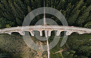 Railway bridge - Viaduct of Telgart in Europe Slovakia from above top view with beautiful pine forest and path under the viaduct