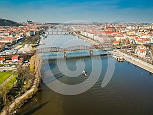 Railway bridge between Vyton and Smichov area above Moldau river with other bridges, Old Town and Prague Castle in background photo