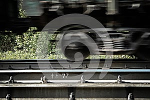 Railway carriage on rails, moving, blured by low shutter speed.