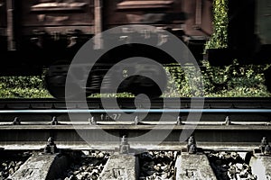 Railway carriage on rails, moving, blured by low shutter speed.
