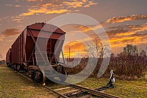 Railway containers with bulk materials.Sunset time