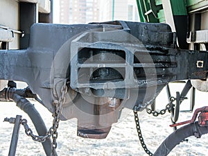 A Railway Coupler between freight cars. End view of coupler, with release lever.