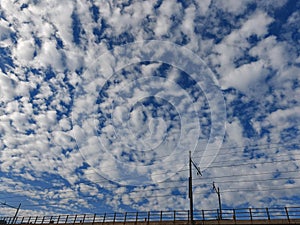 Railway covered by a blue sky full of clouds