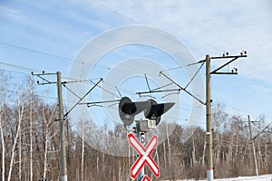 Railway crossing sign with signal lights in winter