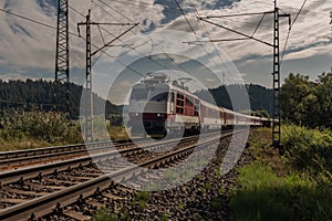 Railway electric track near Liptovsky Hradok station in summer sunny morning