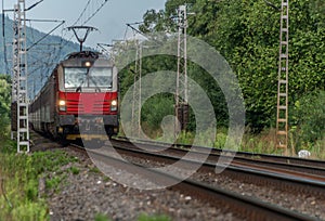 Railway electric track near Liptovsky Hradok station in summer sunny morning