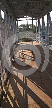 A railway foot over bridge is barricaded for separation of left & right side walk way.