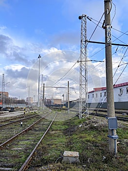 Railway fork, pylons and electrical wires from an industrial building