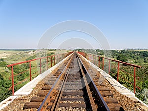 The railway goes across the bridge .