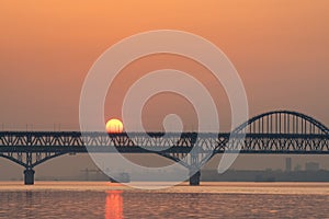 Railway and highway combined bridge in sunrise