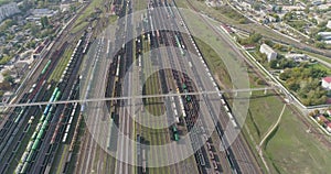 Railway junction with lots of rails top view. Colored trains stand in a large railway depot