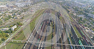 Railway junction with lots of rails top view. Colored trains stand in a large railway depot