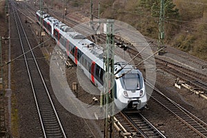 A railway line near Kassel with a silver regional train.