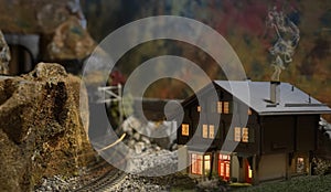 Railway model with house details and blurred steam locomotive