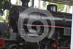 A railway museum displaying old black antique steam locomotives