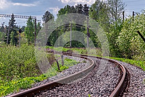 The railway path running through a line with a slightly blurred forground